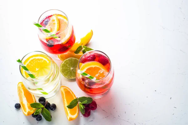 White, pink and red sangria with fruit