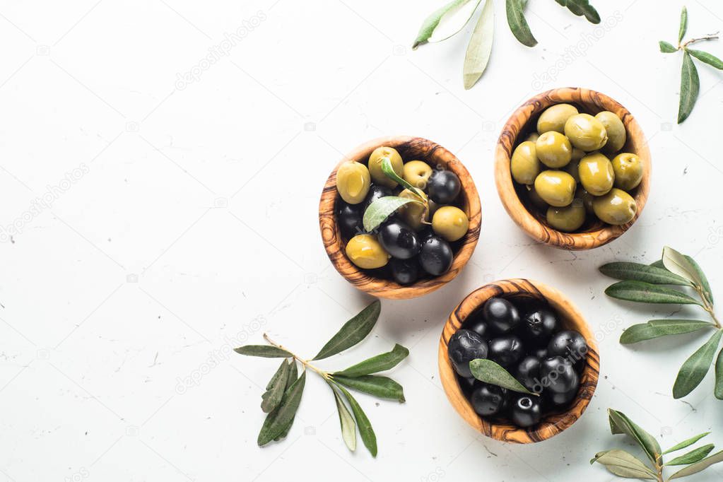 Black and green olives on white.