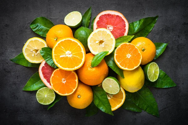 Sortiment čerstvých citrusových plodů na černém pozadí. — Stock fotografie