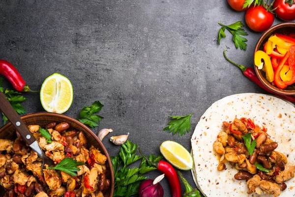 Cooking Mexican taco with meat beans and vegetables.