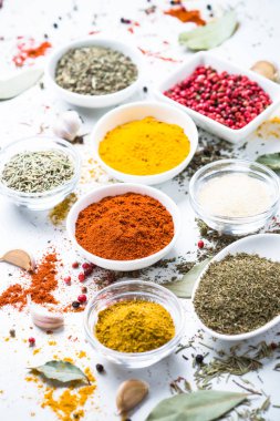 Beyaz bir kase içinde çeşitli baharatlar. 