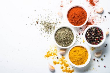 Various spices in a bowls on white.  clipart