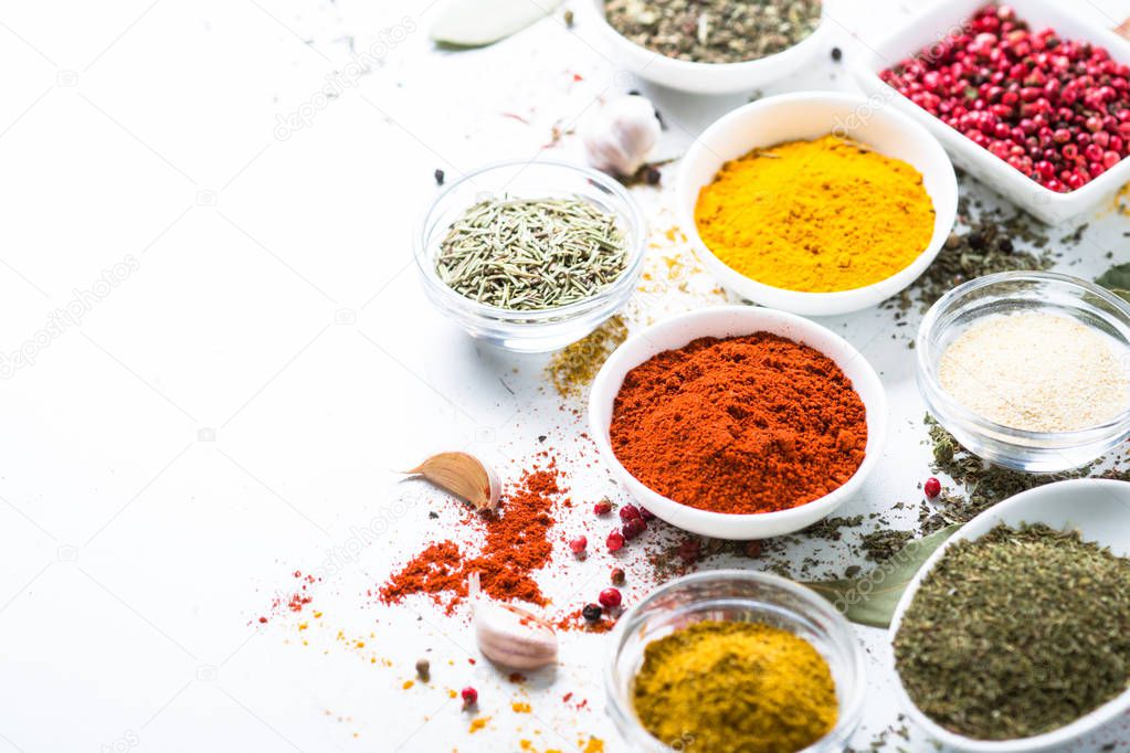 Various spices in a bowls on white. 