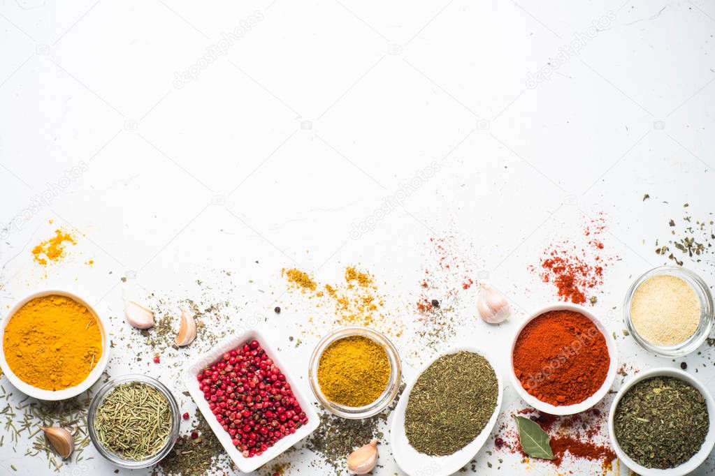 Various spices in a bowls on white. 