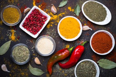 Taş masada bir kase içinde çeşitli baharatlar. 