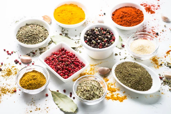 Various spices in a bowls on white table. — Stock Photo, Image