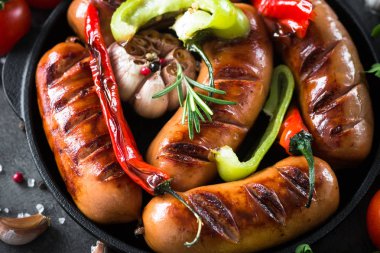 Fried Barbekü sosis sebzeler demir pan.