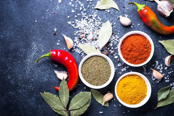 Various spices in a bowls on stone table. — Stock Photo, Image
