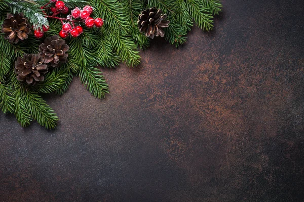 Fir tree pine cones and decorations on dark stone table. — Stock Photo, Image