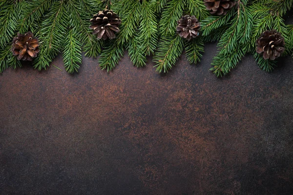 Fir tree pine cones and decorations on dark stone table. — Stock Photo, Image