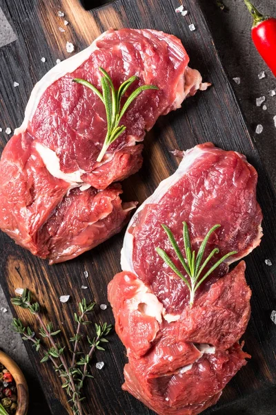 Raw beef steak with herbs. — Stock Photo, Image