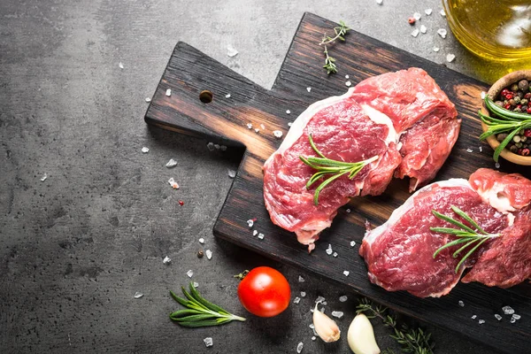 Raw beef steak with herbs. — Stock Photo, Image