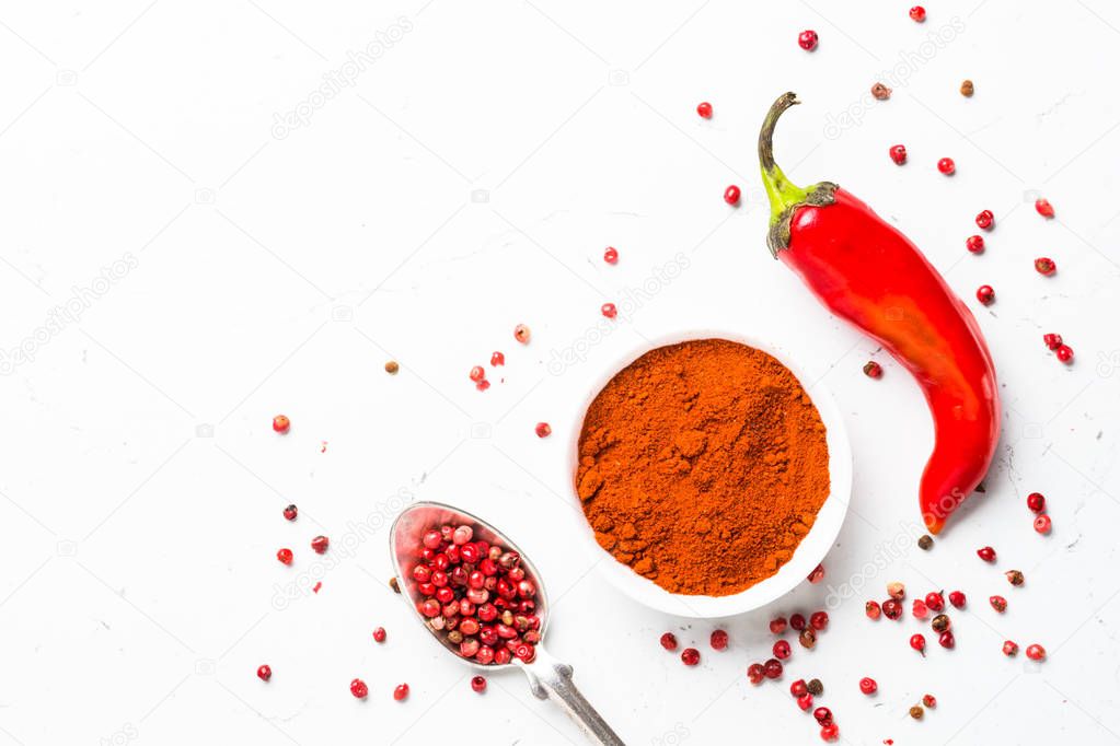 Ground pepper, peppercorn and fresh chili pepper on white 