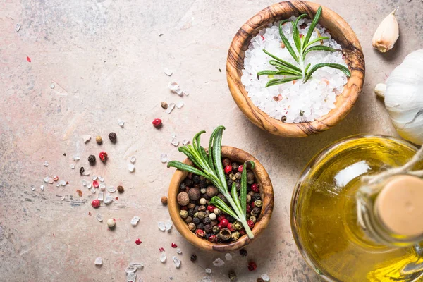 Spices and herbs background - olive oil rosemary on stone table. — Stock Photo, Image