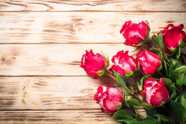 Rosa roja sobre mesa de madera . — Foto de Stock