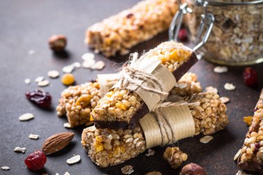 Granola barlar karanlık taş masada. 
