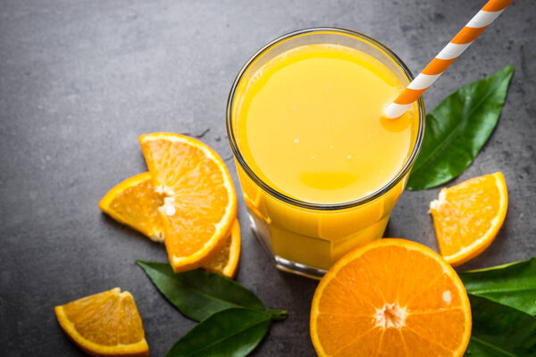 Orange juice in glass on black.