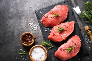 Biberiye ve baharat siyah arka plan üzerine sığır eti biftek