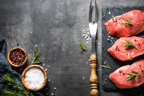 Marha steak és a fűszerek, a fekete háttér — Stock Fotó