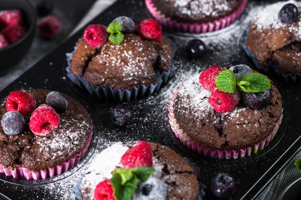 Chocolate orange muffins or cupcakes with berries. — Stock Photo, Image