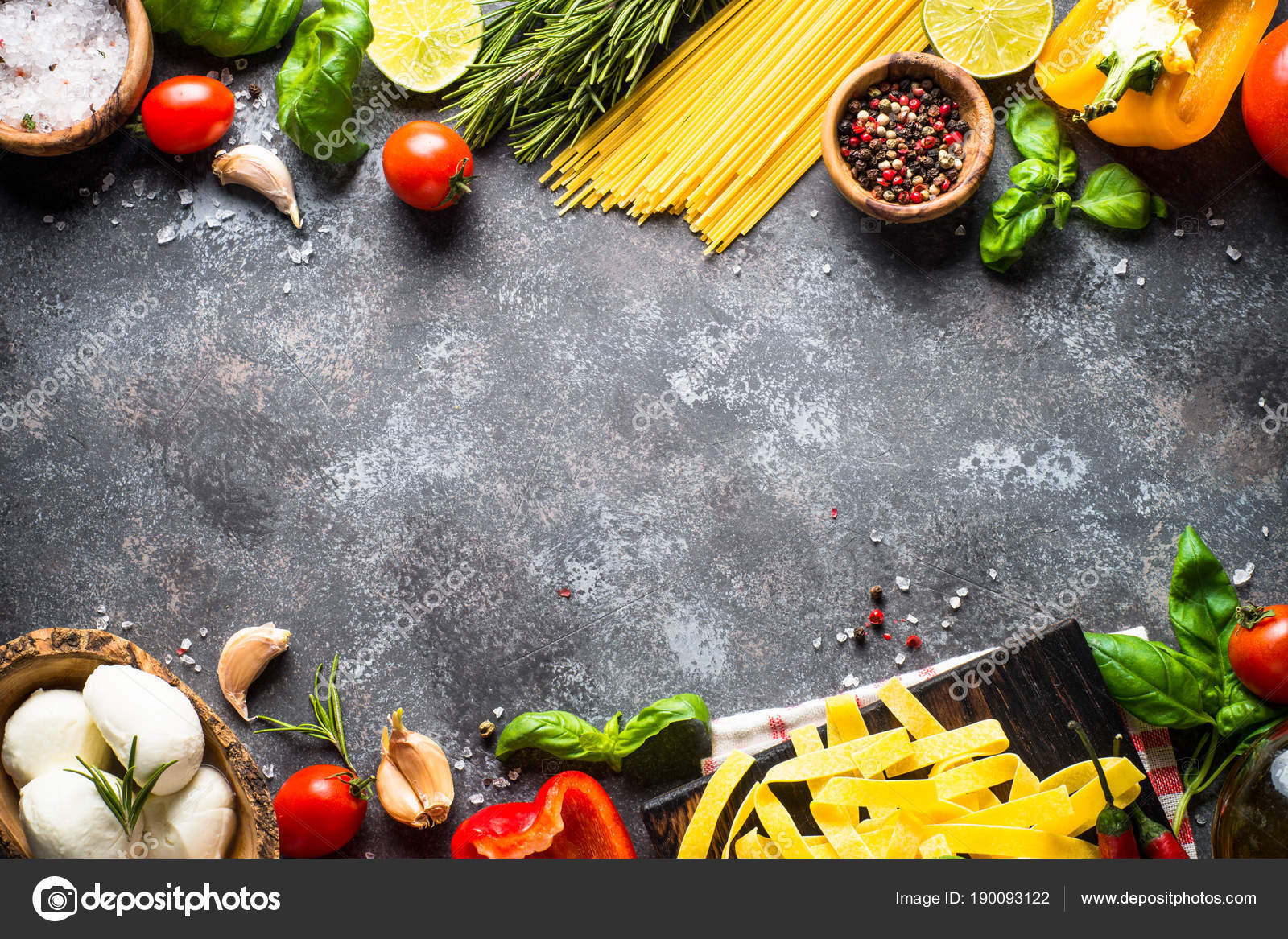 Italian food background. Pasta, herbs, vegetables on black top v 