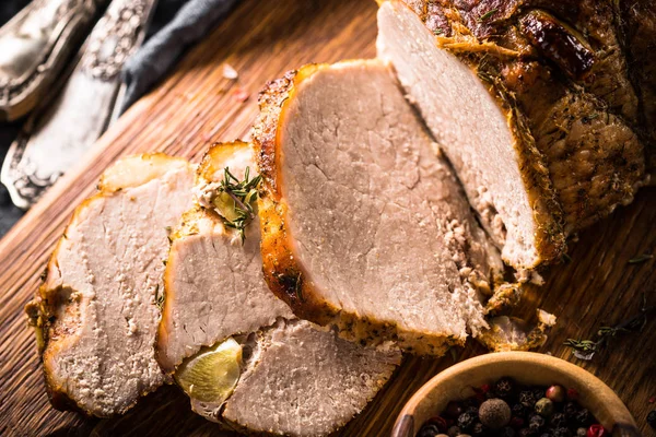 Baked pork meat sliced close up.