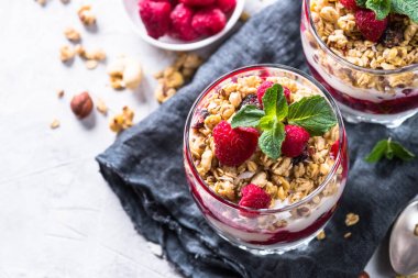 Katmanlı tatlı yoğurt, granola, reçel ve ahududu.