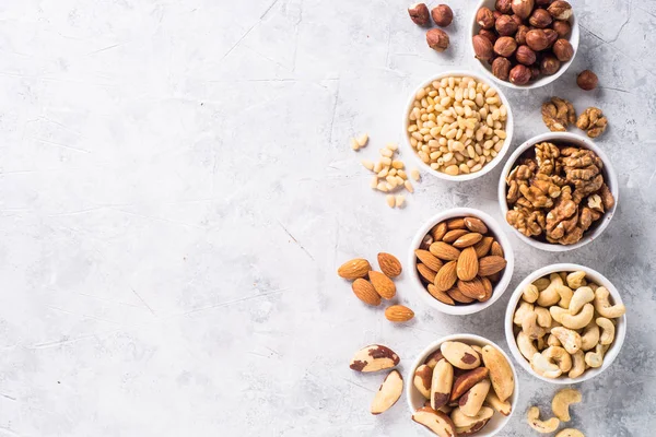 Nuts assortments on stone table top view. — Stock Photo, Image