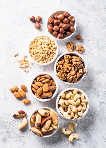 Nuts assortments on stone table top view. — Stock Photo, Image