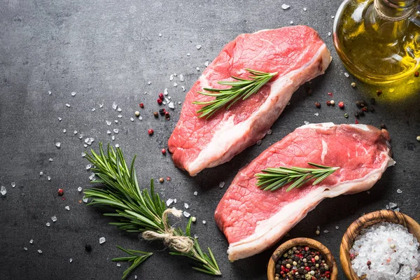 Raw beef striploin steak with herbs and spices. — Stock Photo, Image