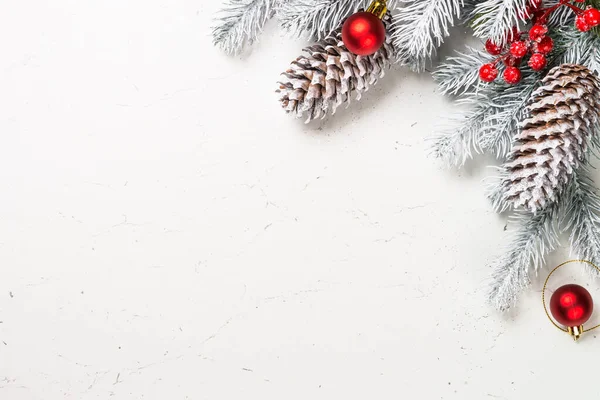 Christmas background with fir tree and decorations on white. — Stock Photo, Image