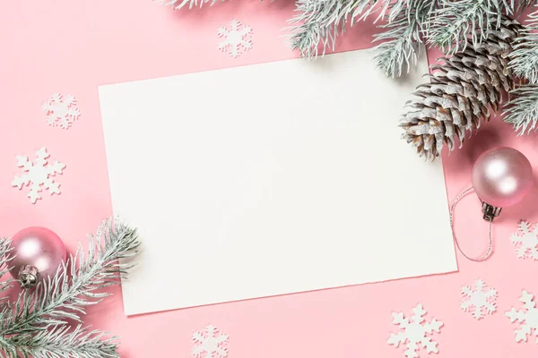 Christmas greeting card with empty blank sheet, fir tree and decorations on pink. — Stock Photo, Image