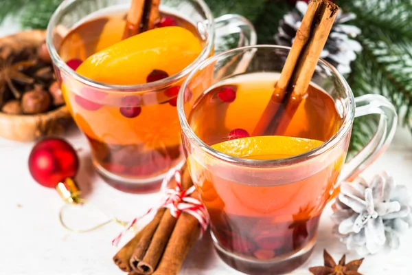 Winter hot tea with orange, cranberry and spices. — Stock Photo, Image