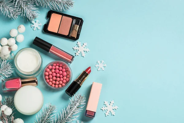 Makeup products, skincare product with christmas decorations.