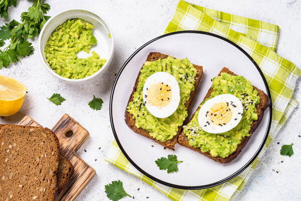 Avocado Sandwiches on white background.