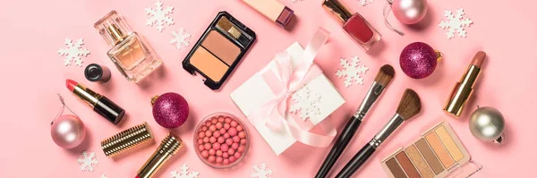 Makeup professional cosmetics with christmas decor on pink. — Stock Photo, Image