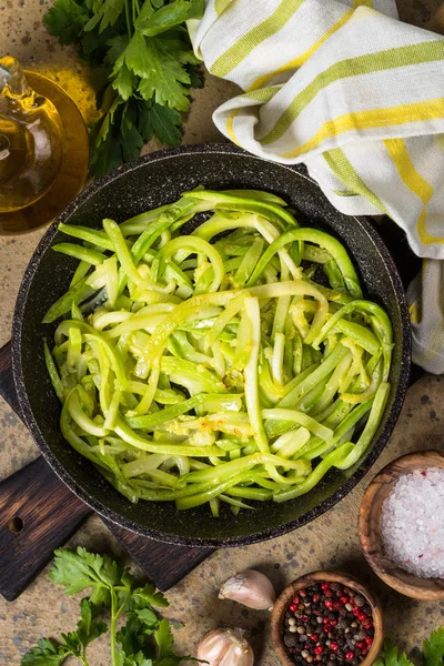Zucchini noodles in frying pan top view. — Stock Photo, Image