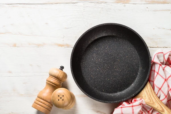 Frying pan or skillet on white wooden table. — Stock Photo, Image