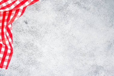 Kitchen table with plaid red napkin.