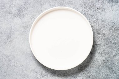 Kitchen table with white plate.