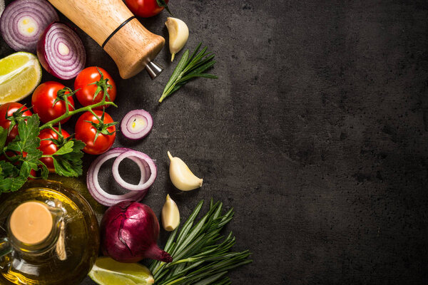 Ingredients for cooking at black table.