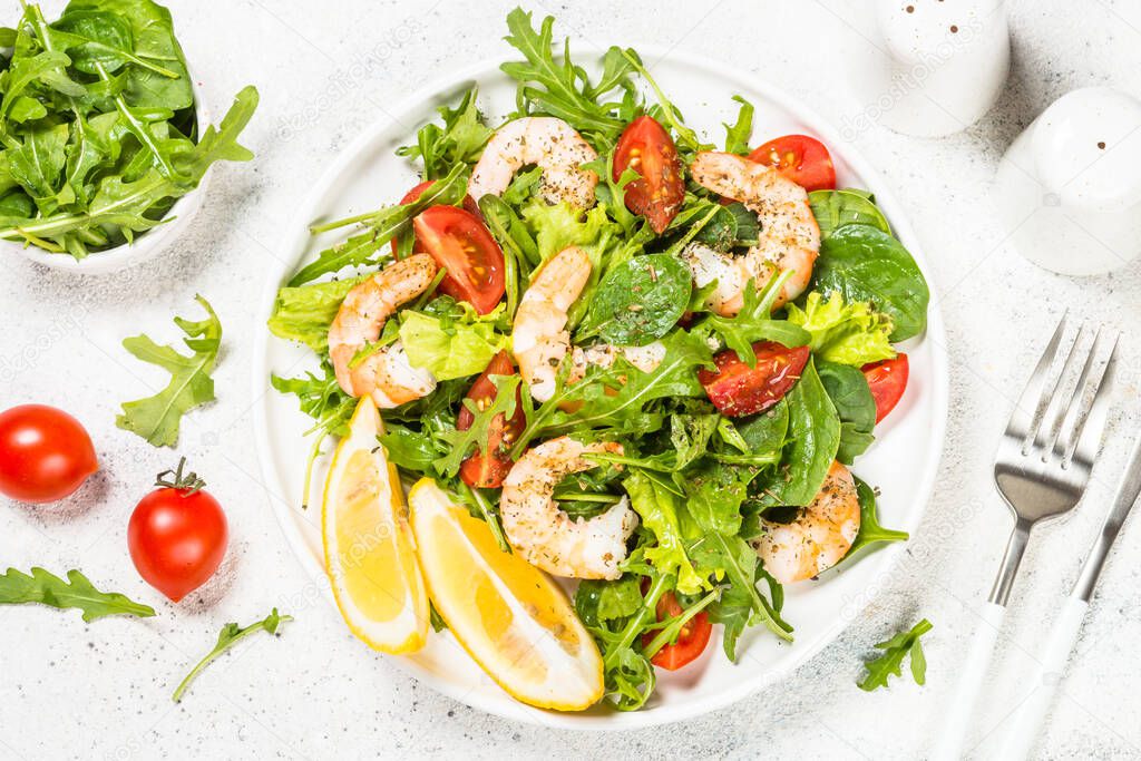 Shrimp salad with vegetables and leaves.