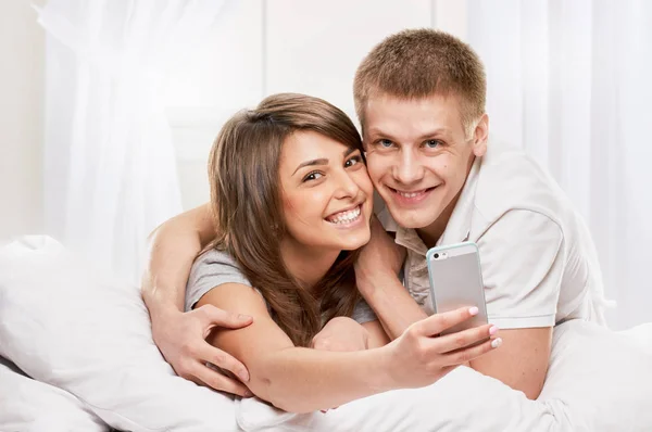 Smiling portrait of Couple lying in bed — Stock Photo, Image