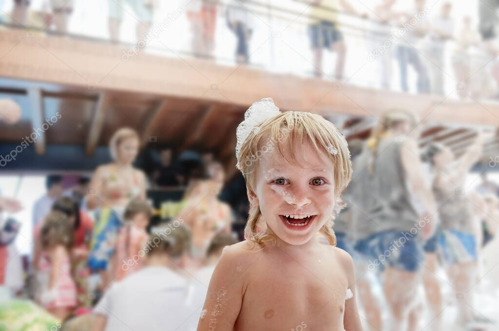 Laughing boy in foam