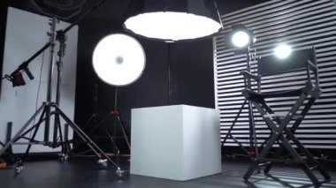 Siyah ve Beyaz Siklonama. Karanlık oda. Profesyonel ekipmanlı modern fotoğraf stüdyosu. Işık ekipmanlı boş fotoğraf stüdyosu. Yönetmen prodüksiyon koltuğuyla modern fotoğraf stüdyosunun içi..