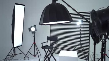 Siyah ve Beyaz Siklonama. Karanlık oda. Profesyonel ekipmanlı modern fotoğraf stüdyosu. Işık ekipmanlı boş fotoğraf stüdyosu. Yönetmen prodüksiyon koltuğuyla modern fotoğraf stüdyosunun içi..