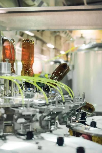 Empty plastic PET bottles in a filling machine.