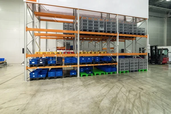 Long shelves with a variety of boxes and containers.