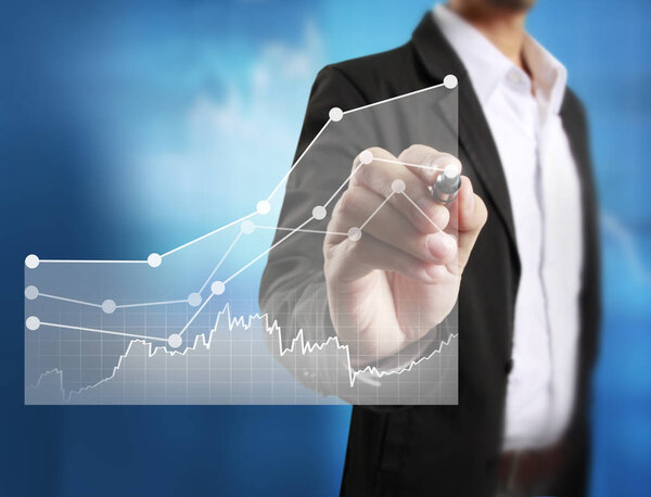 Businessman drawing graphics  growing graph