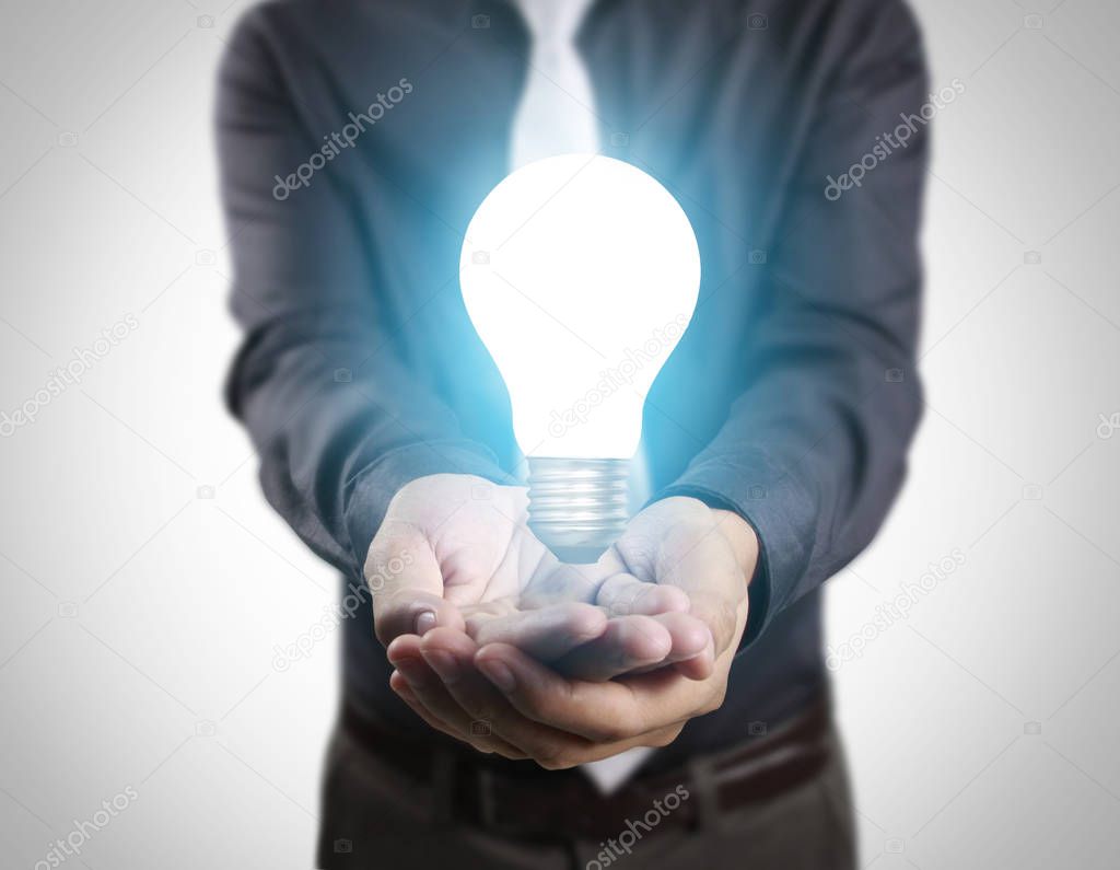  business person holding light bulb 